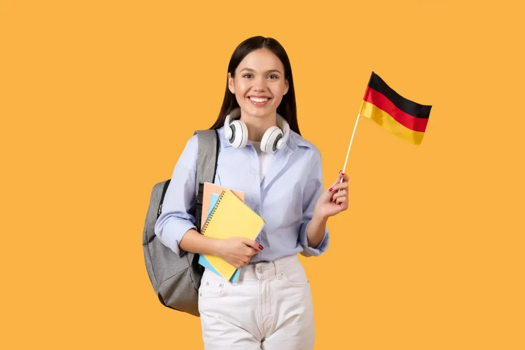 Student holding flag with German visa, ready to study abroad
