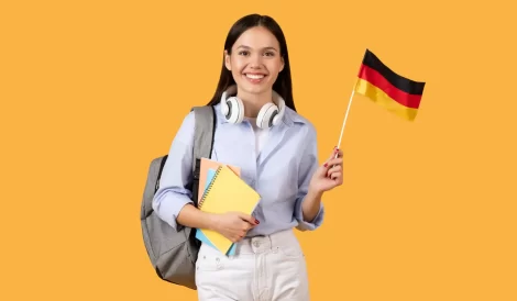 Student holding flag with German visa, ready to study abroad