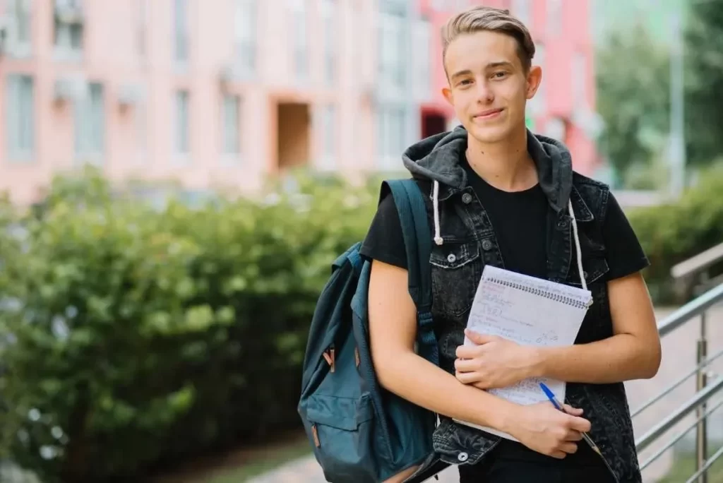 Student at the leading German language institute in Cochin, Kerala holding notes and backpack