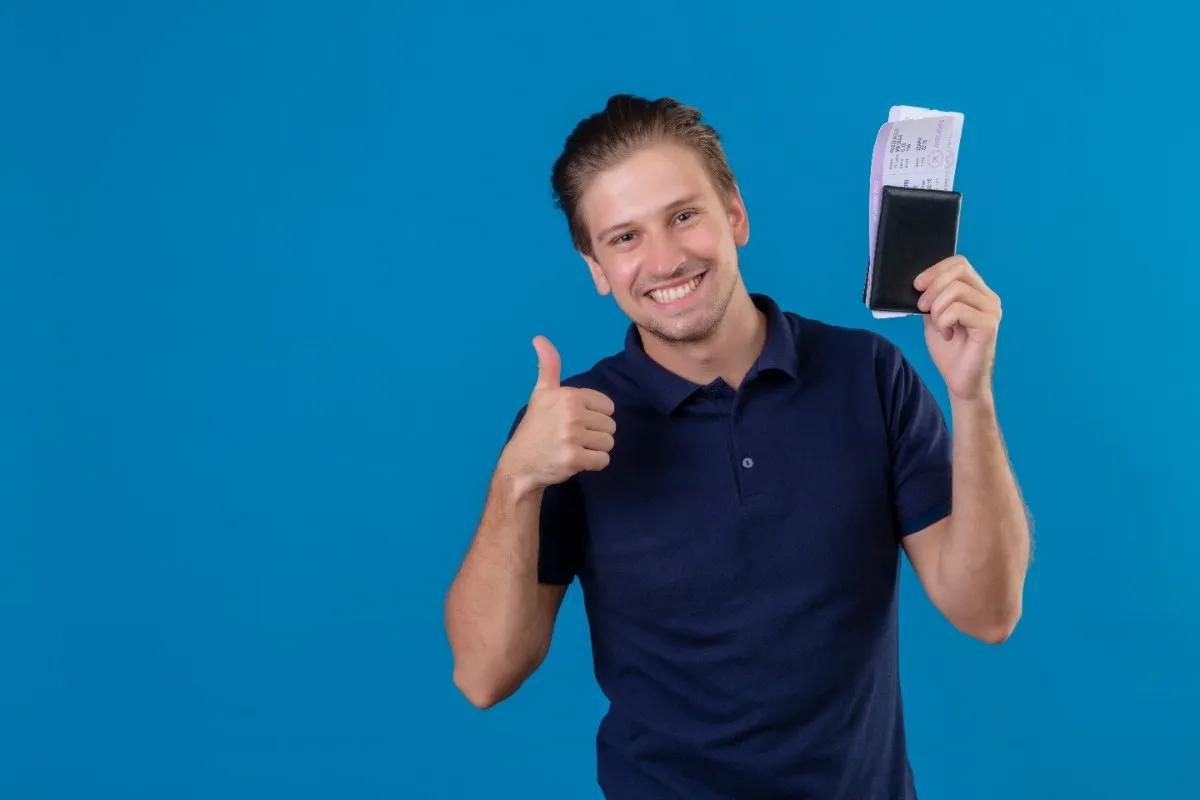 Smiling traveler holding a passport and boarding pass, representing the Germany Blue Card for Indians and career opportunities in Germany.