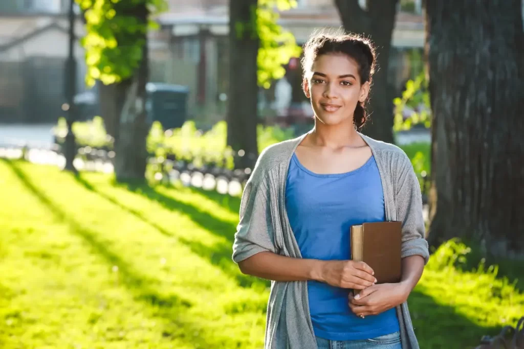 Indian student holding books outdoors, representing Germany immigration updates 2026 for Indians planning higher studies and career opportunities in Germany.
