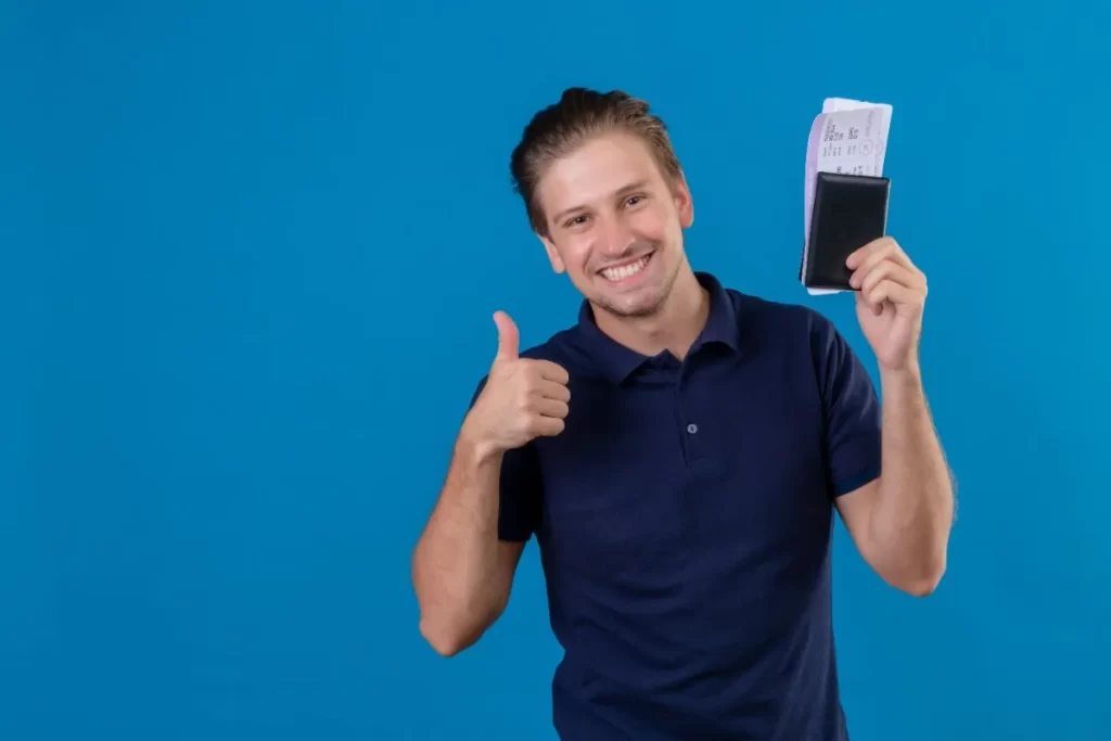 Smiling traveler holding a passport and boarding pass, representing the Germany Blue Card for Indians and career opportunities in Germany.